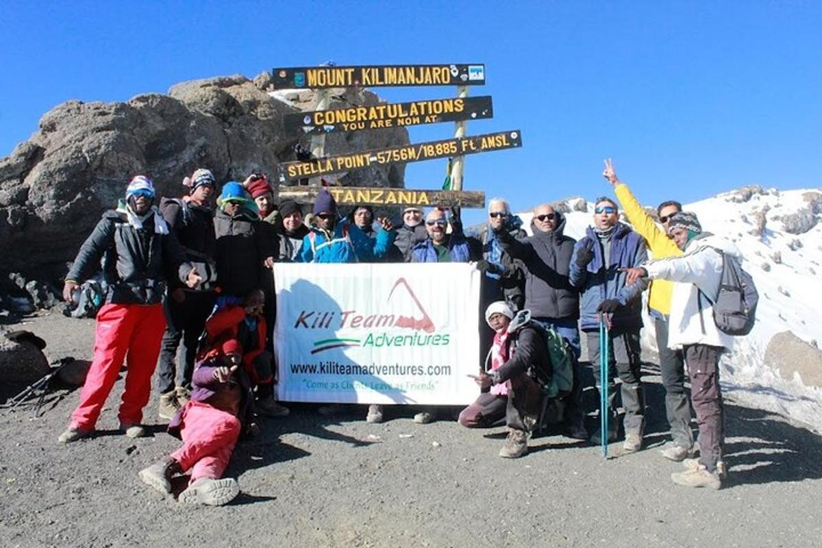 a group of people posing for a picture on a mountain