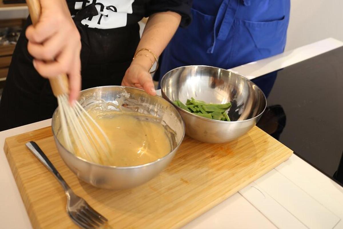 a person stirring a bowl with a whisk