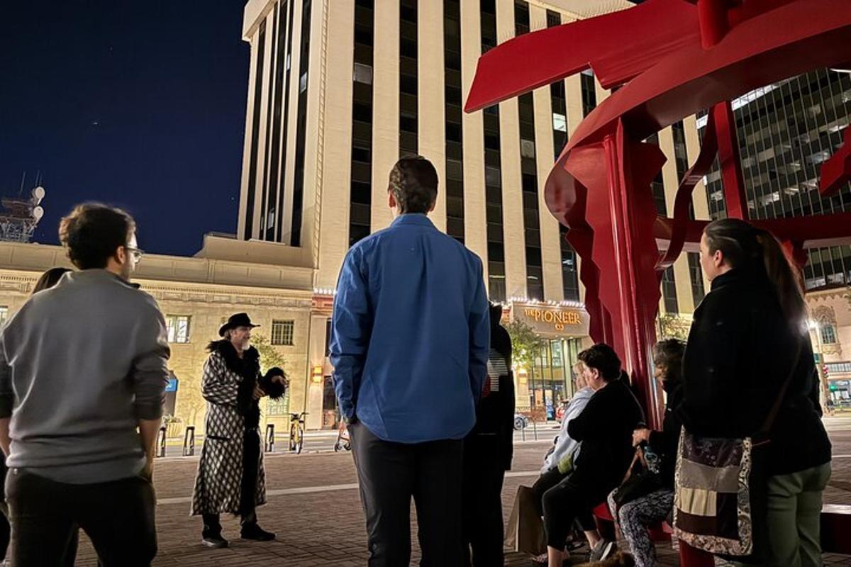 a group of people standing around in front of a building