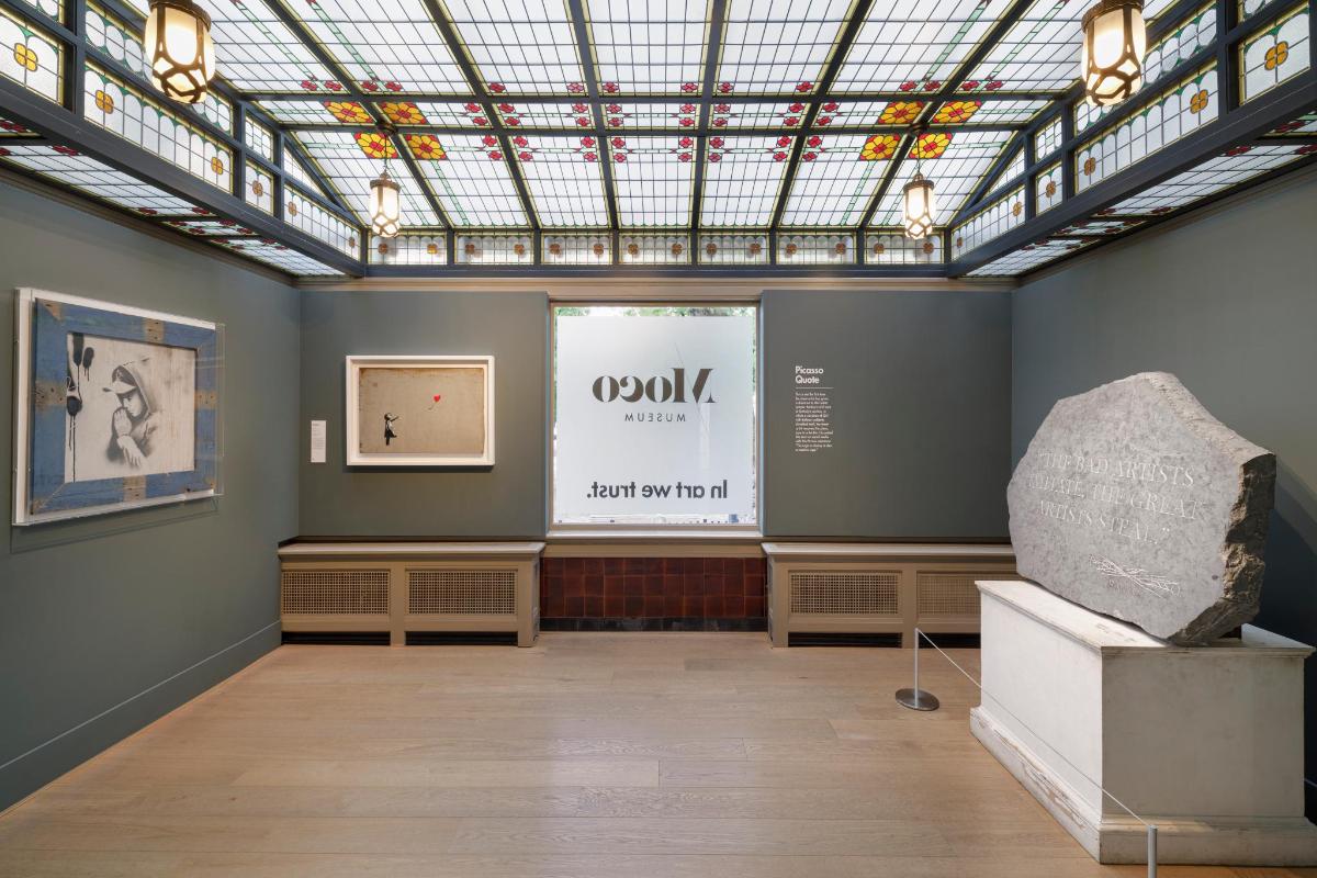a museum exhibit with a large window and a large rock