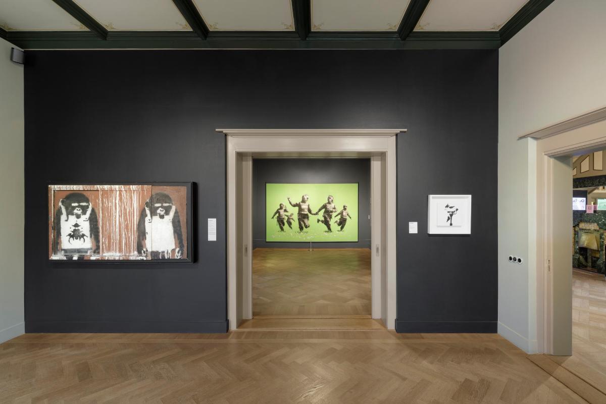 a room with two paintings on the wall and a hallway