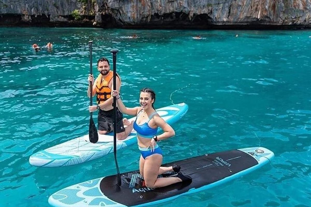 a man and a woman on a paddle board in the water