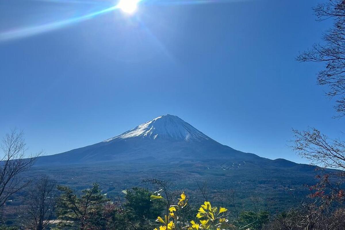 a mountain in the distance with the sun in the sky