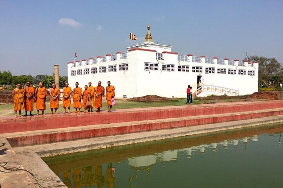 a group of people in orange uniforms standing in front of a building
