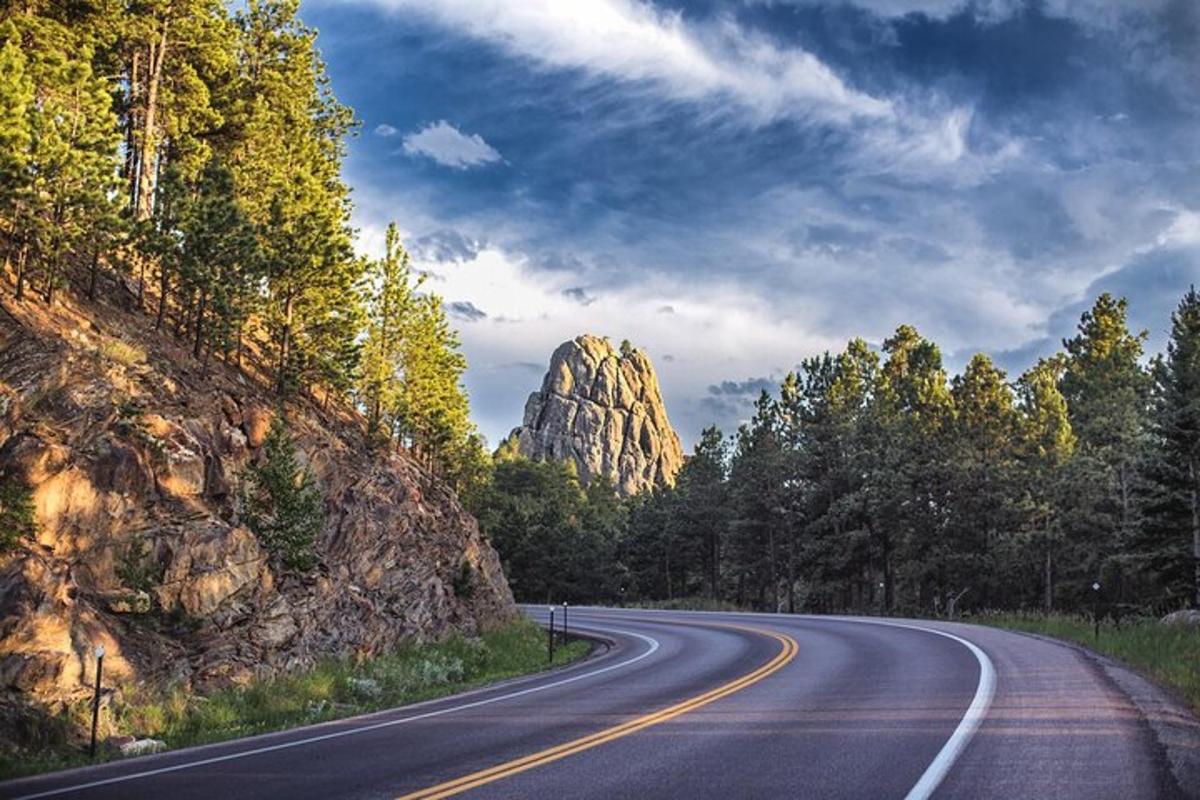 an empty road with a mountain in the background