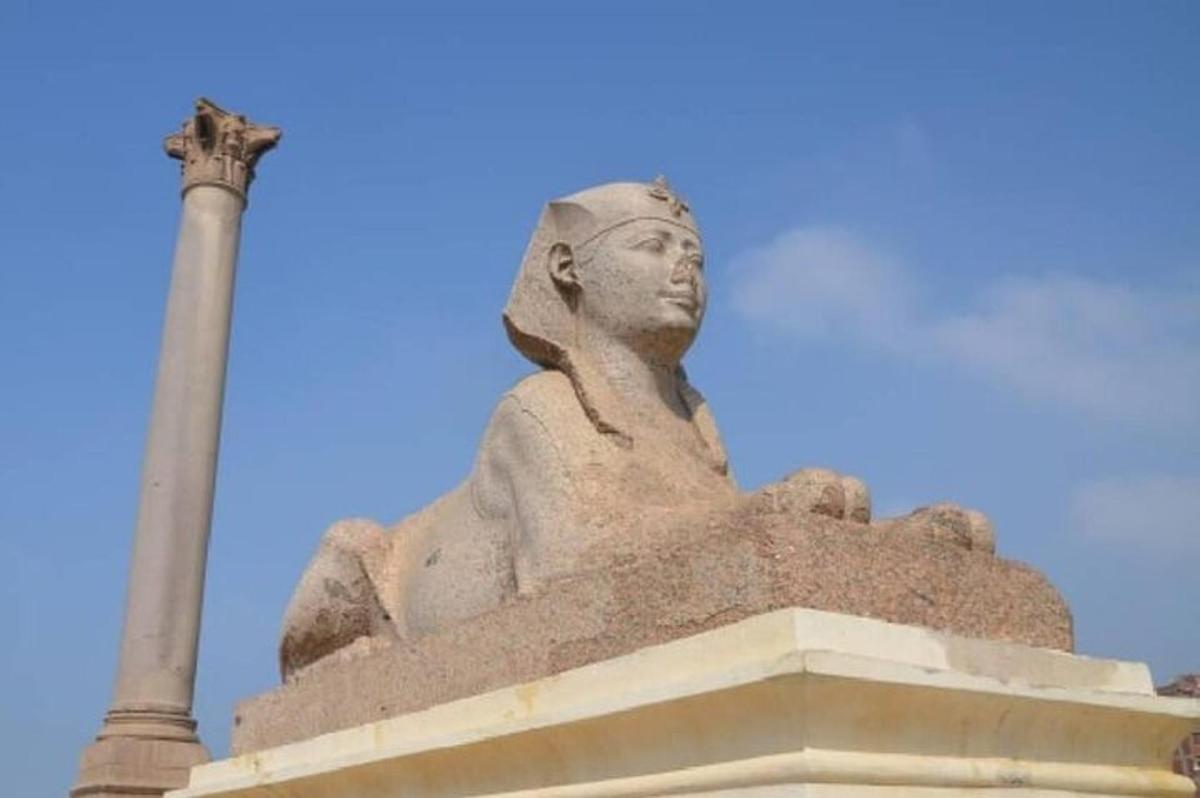 una statua di una donna seduta in cima a un monumento