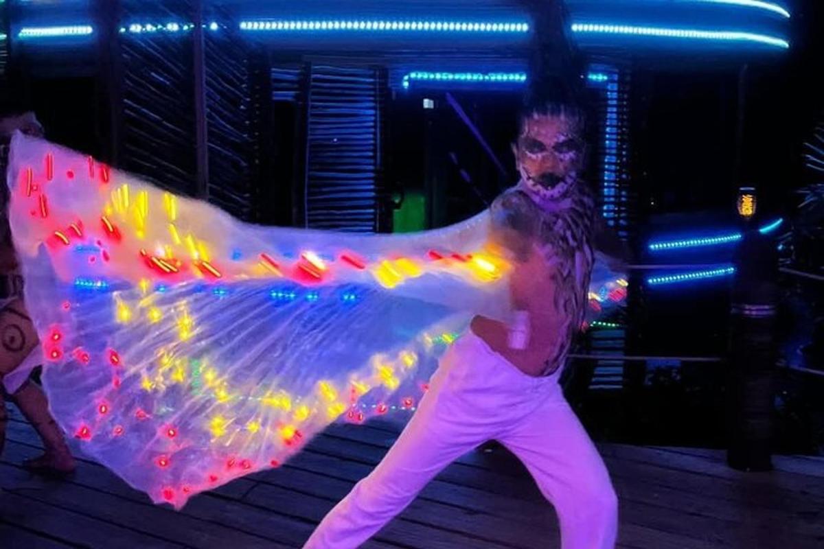 a man is standing in a party with a costume