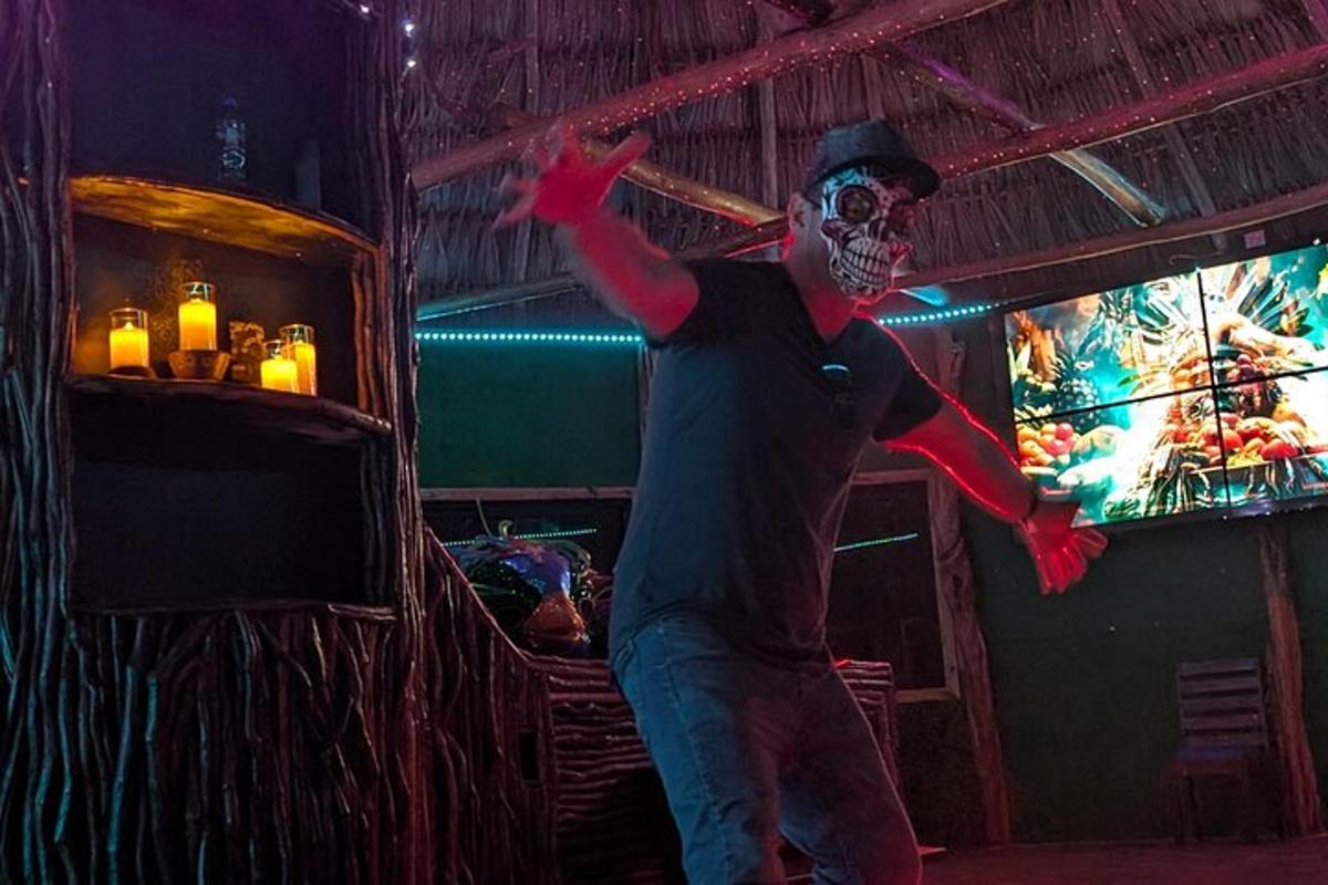a man wearing a skeleton mask standing in front of a tv