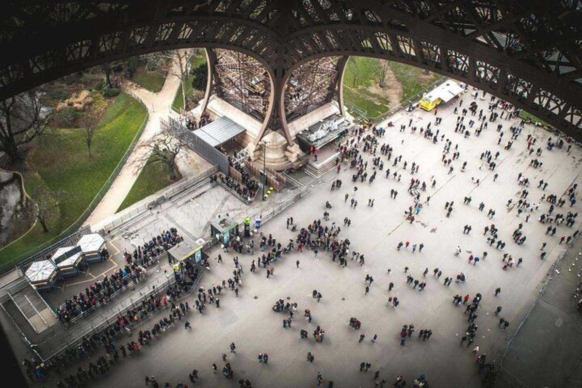 a large group of people walking under a bridge