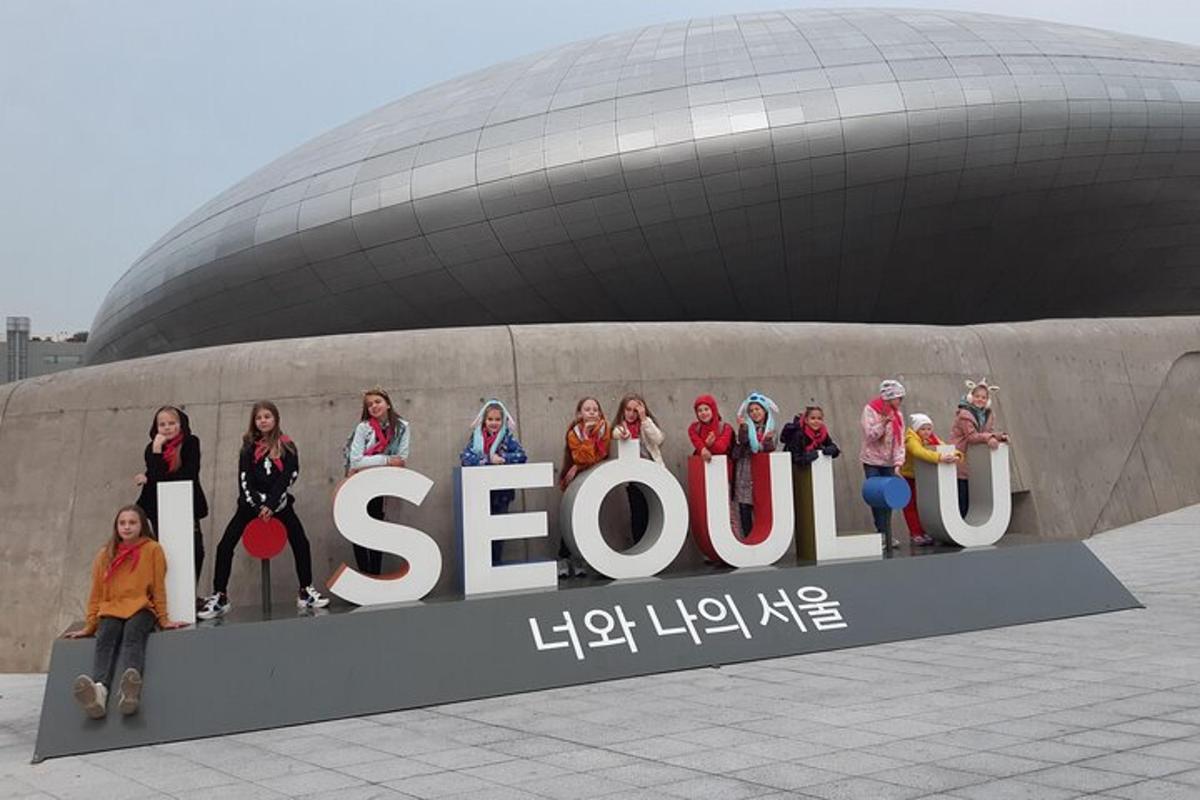 sekumpulan orang berdiri di hadapan papan tanda seoul