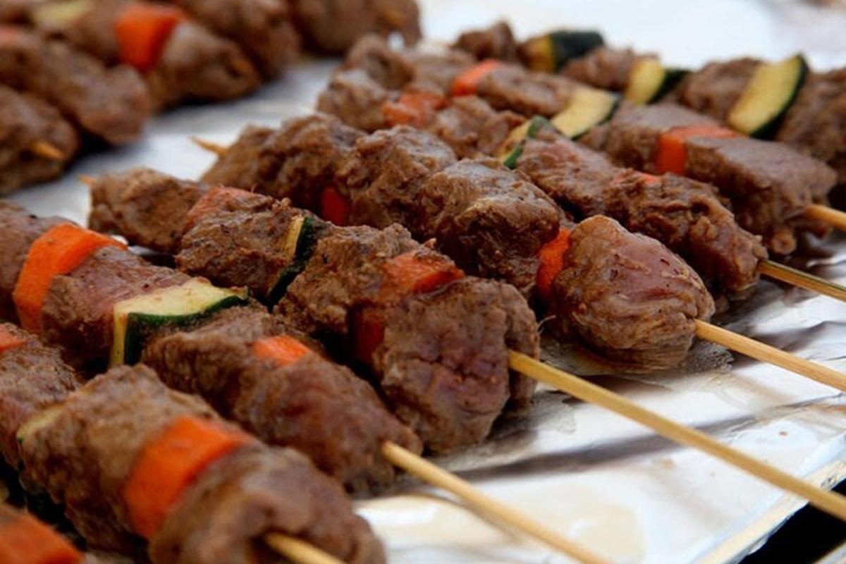 a bunch of food on skewers on a table
