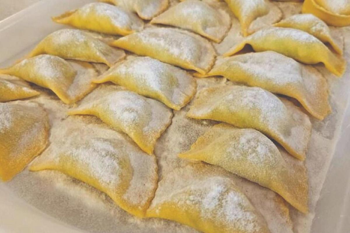 a plate of dumplings with yellow sauce on it