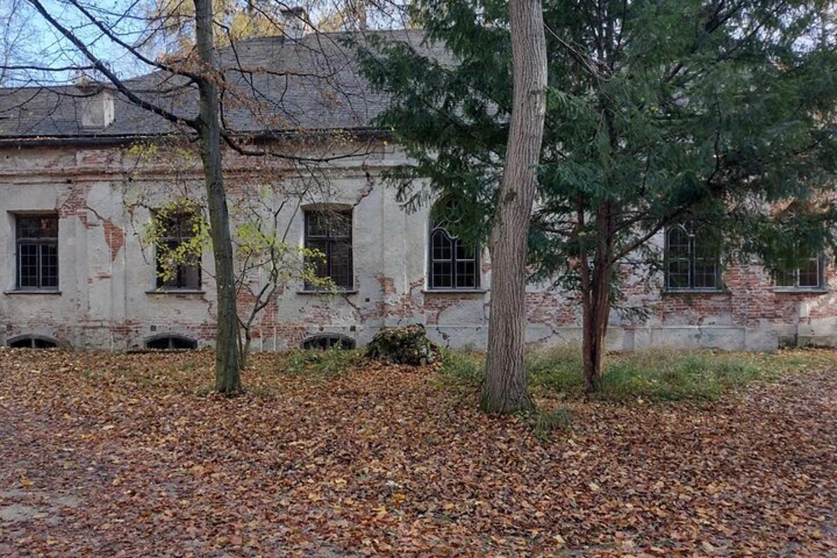 an old stone building with trees in front of it