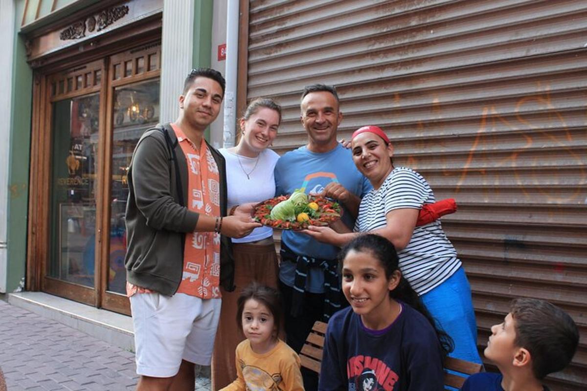 a group of people posing for a picture with a bunch of vegetables