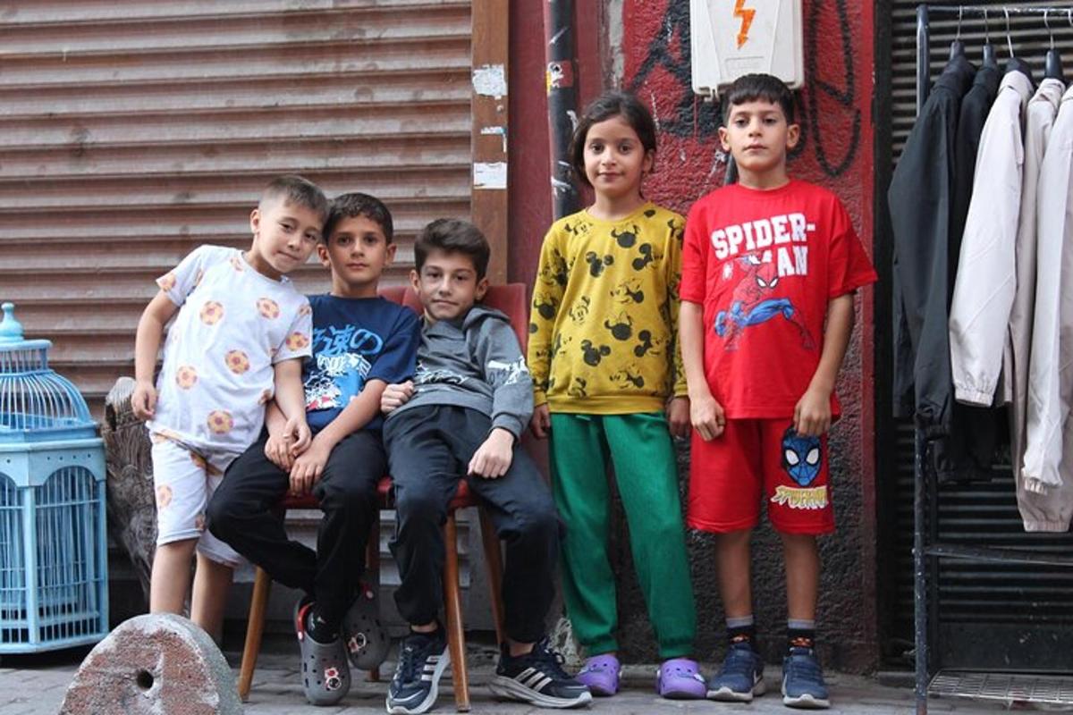 a group of young boys sitting on a bench