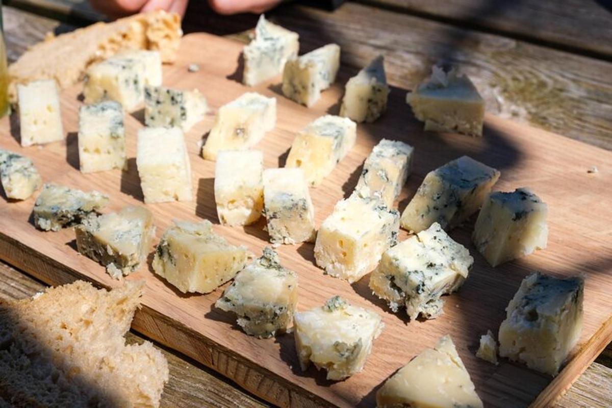 a bunch of cheese on a wooden cutting board