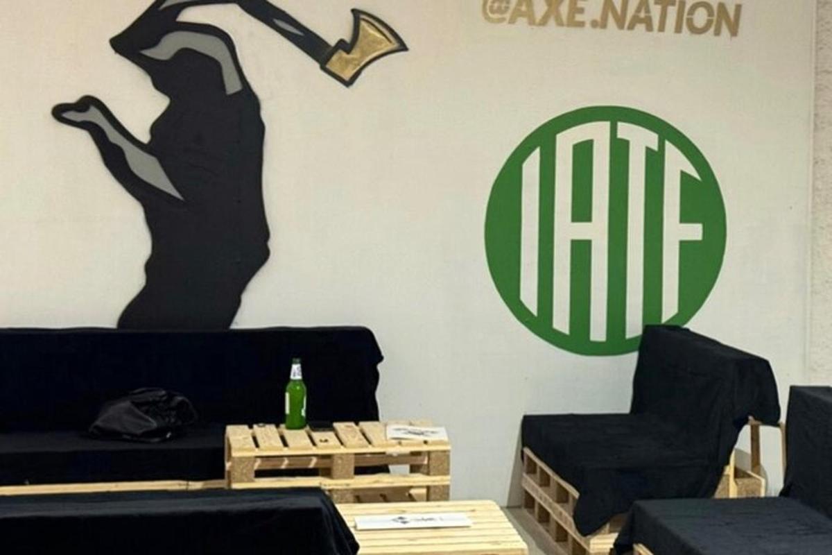 a living room with a couch and a sign on the wall