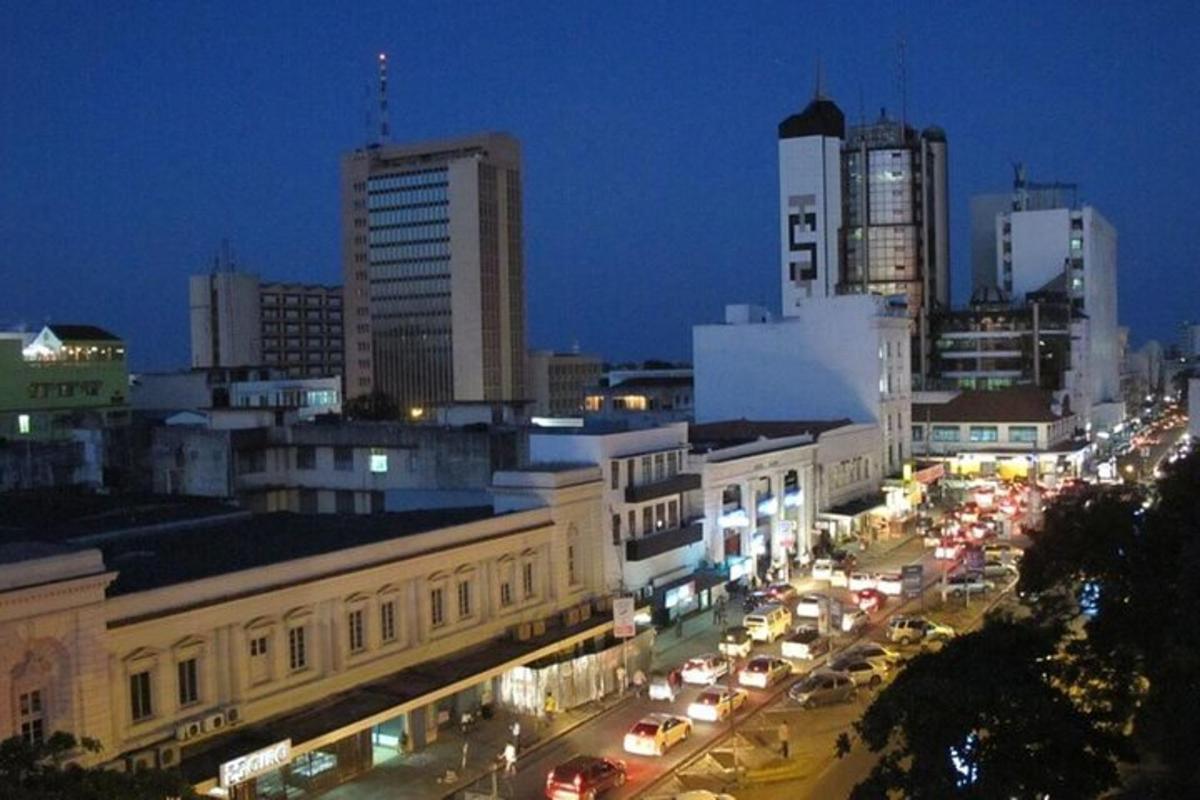 a city at night with cars on a busy street