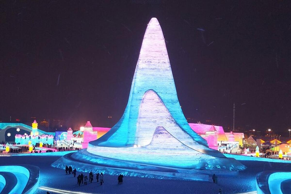 a large ice sculpture is lit up at night