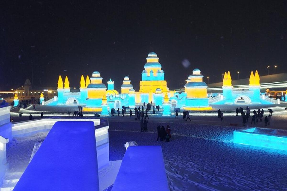 a large ice structure with people walking around it at night