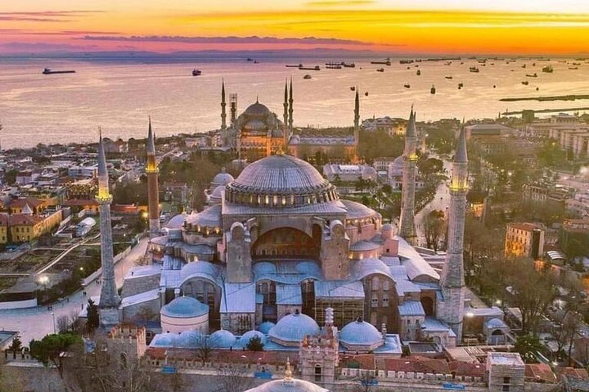 a building with a mosque with a sunset in the background