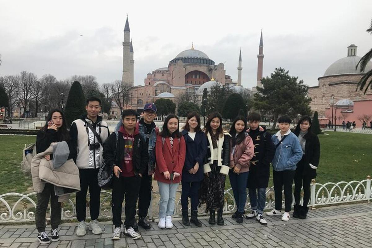 a group of people standing in front of a mosque