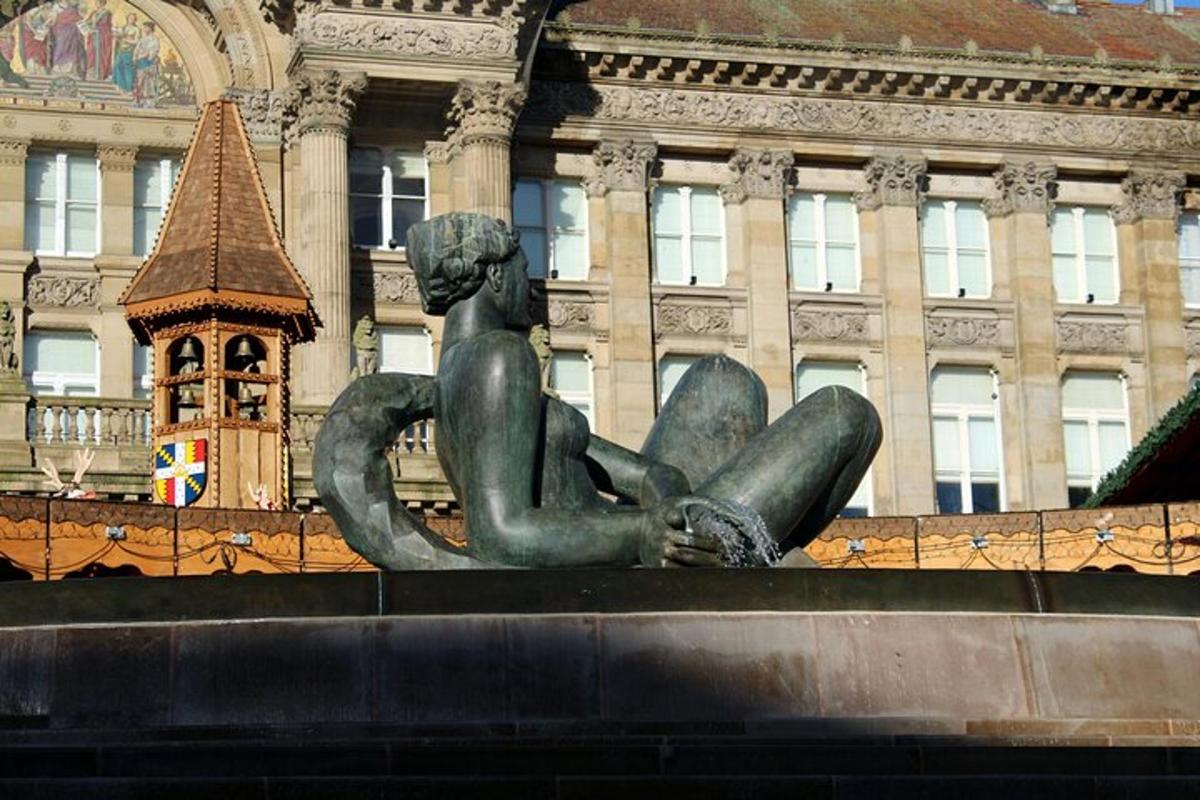 a statue of a woman sitting in front of a building