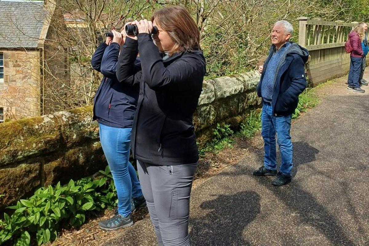 a woman taking a picture of a man with a camera