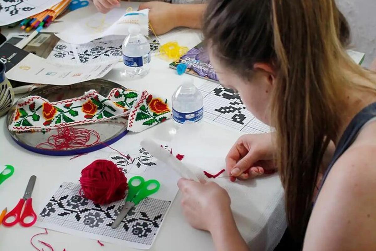 a young girl cutting out a piece of paper with scissors