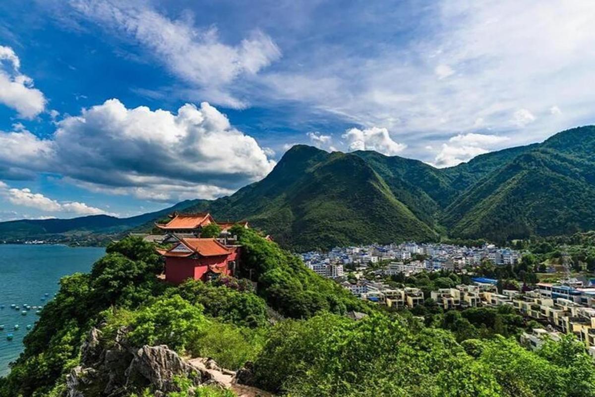 a view of a city on a hill next to the water