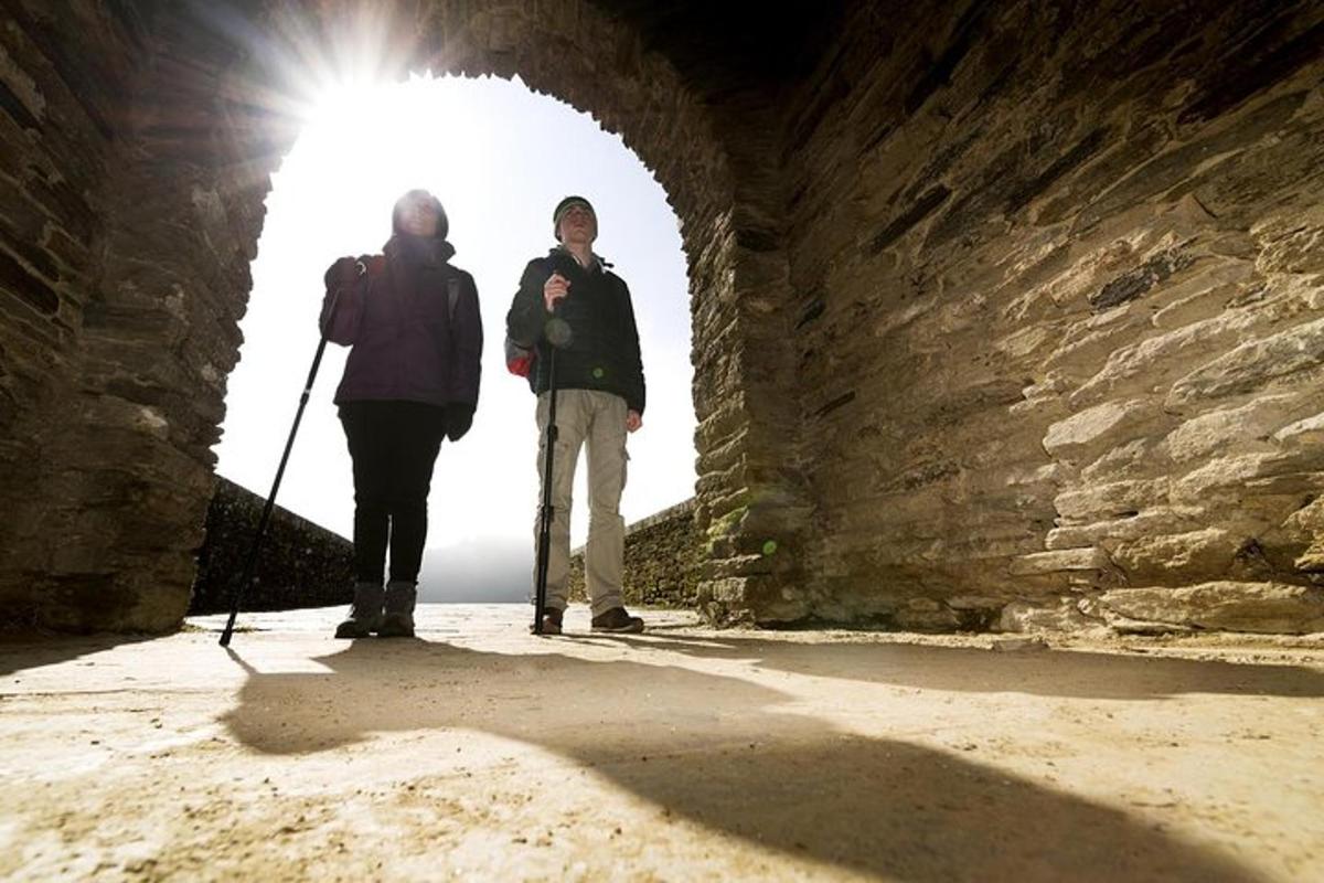 two people are standing in a tunnel
