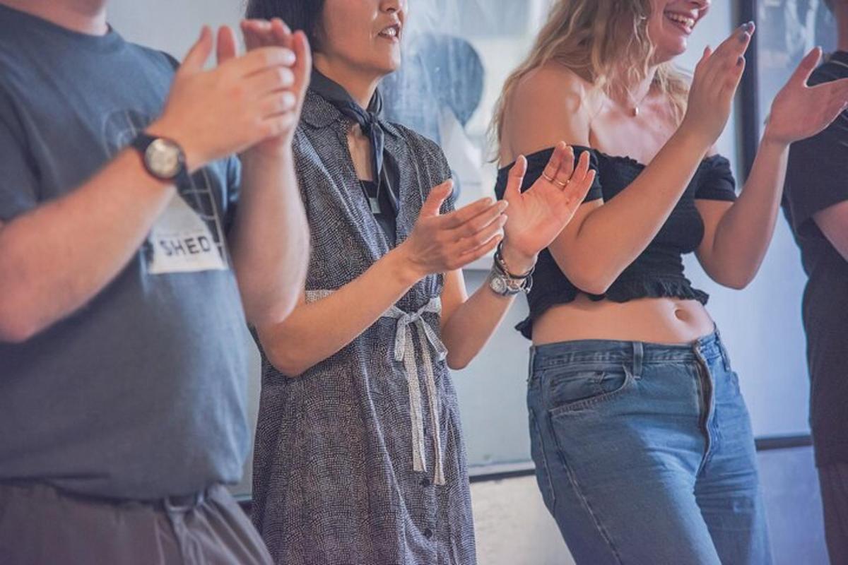 a group of people clapping in a room