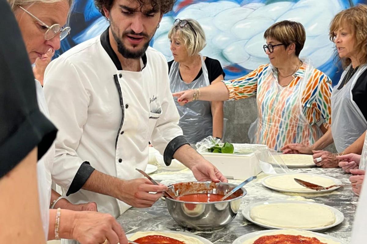 a chef preparing food in front of a group of people