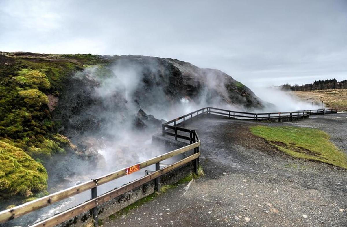a view of a waterfall with steam coming out of it