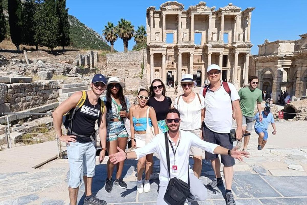 a group of people posing in front of the coliseum
