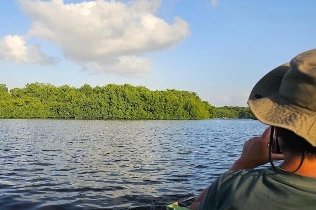a person in a hat on a boat on a lake