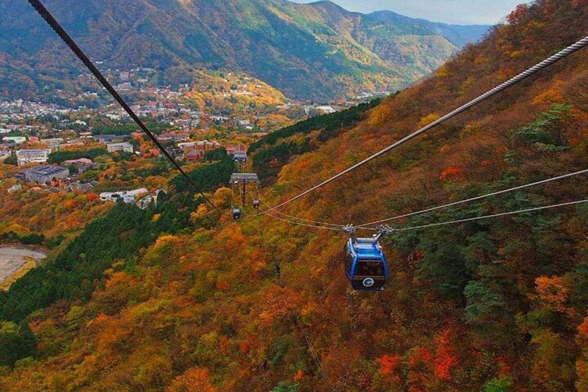 a gondola flying through the air over a mountain