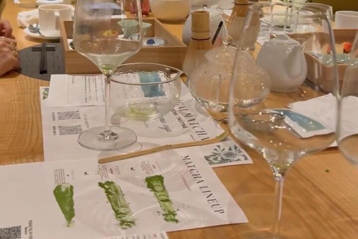 a table with wine glasses and vegetables on it