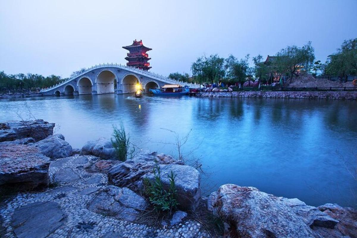 a bridge over a river with a tower in the background