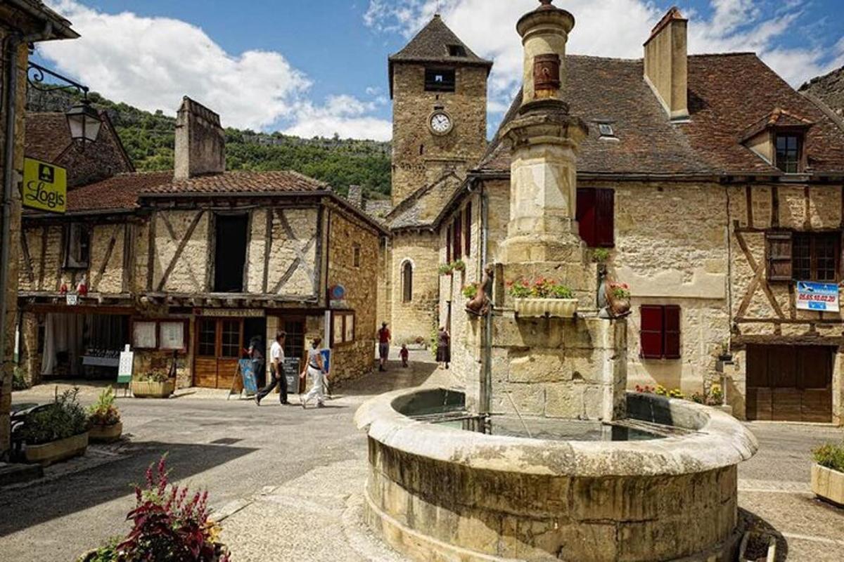 an old building with a fountain in the middle of a street