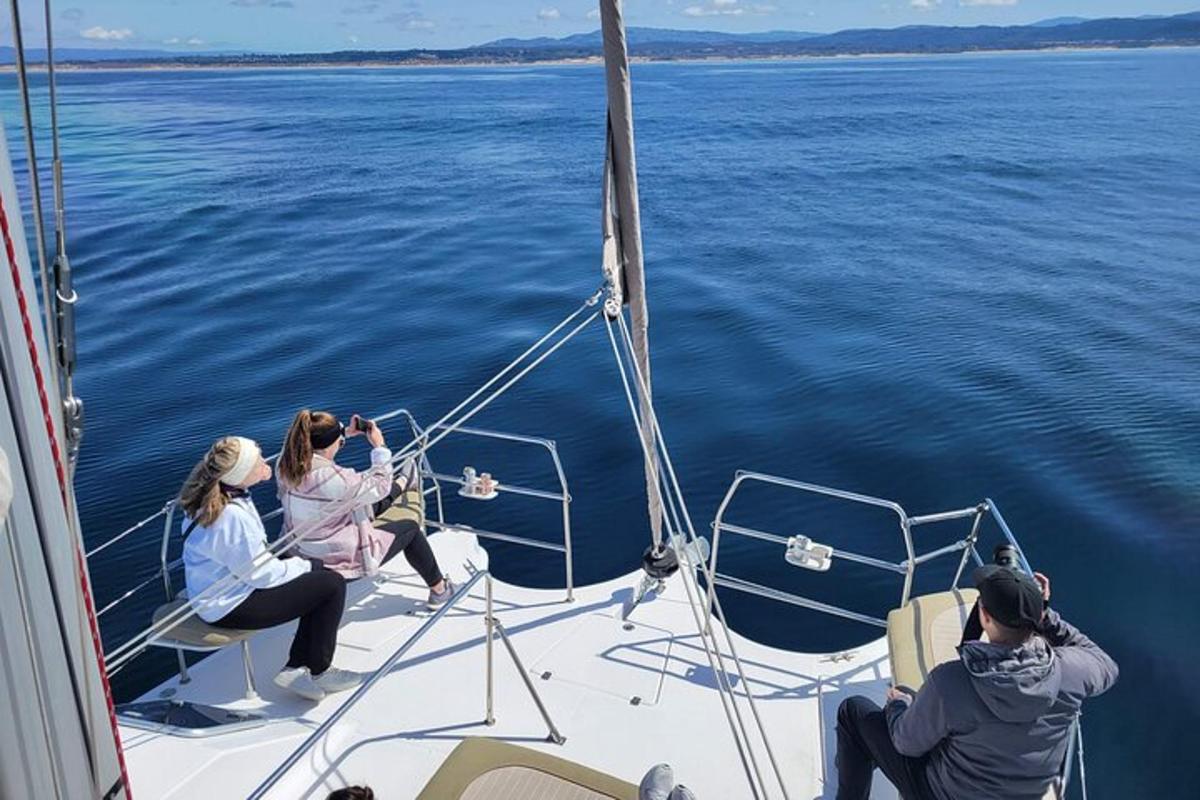 a group of people sitting on a boat in the water