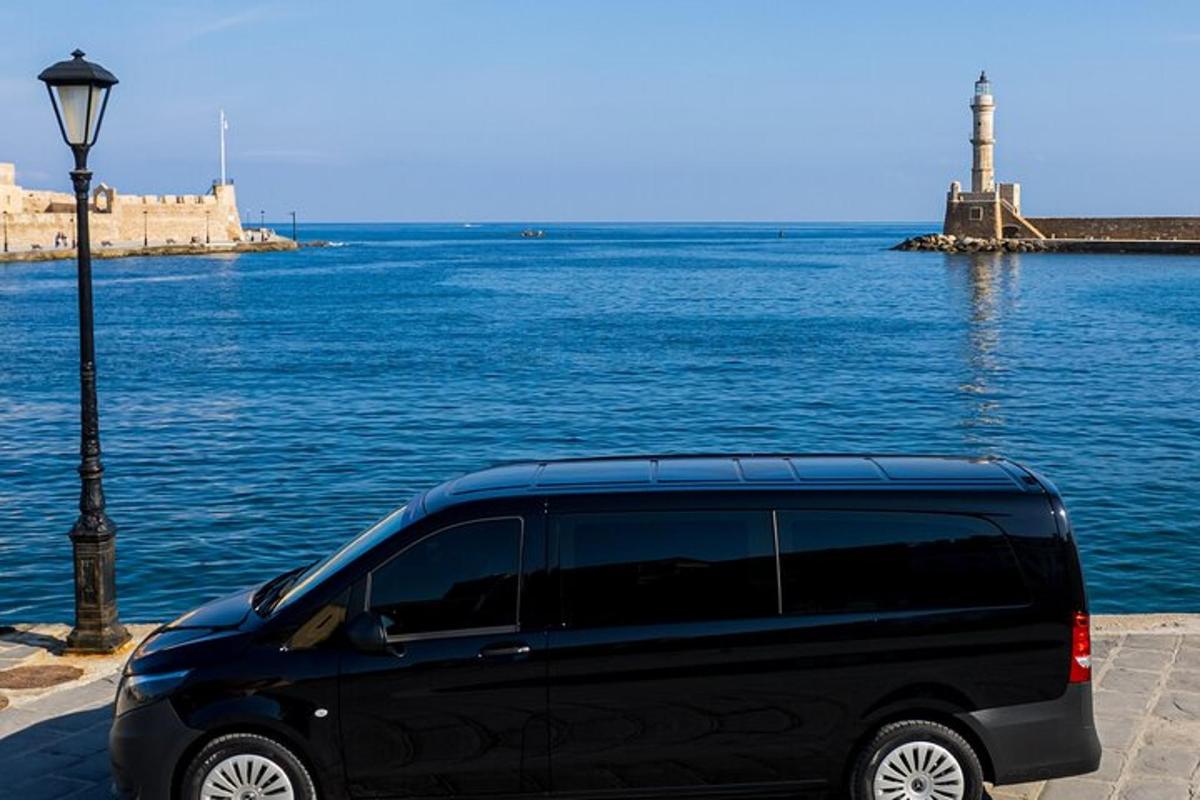 a black van parked next to a body of water