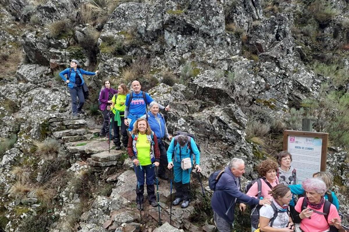 a group of people standing on a mountain trail