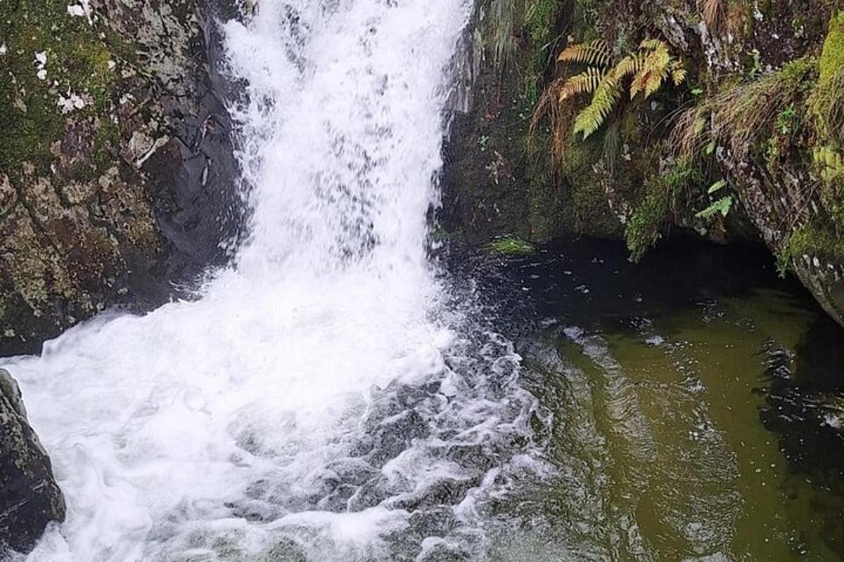 a waterfall in the middle of a river