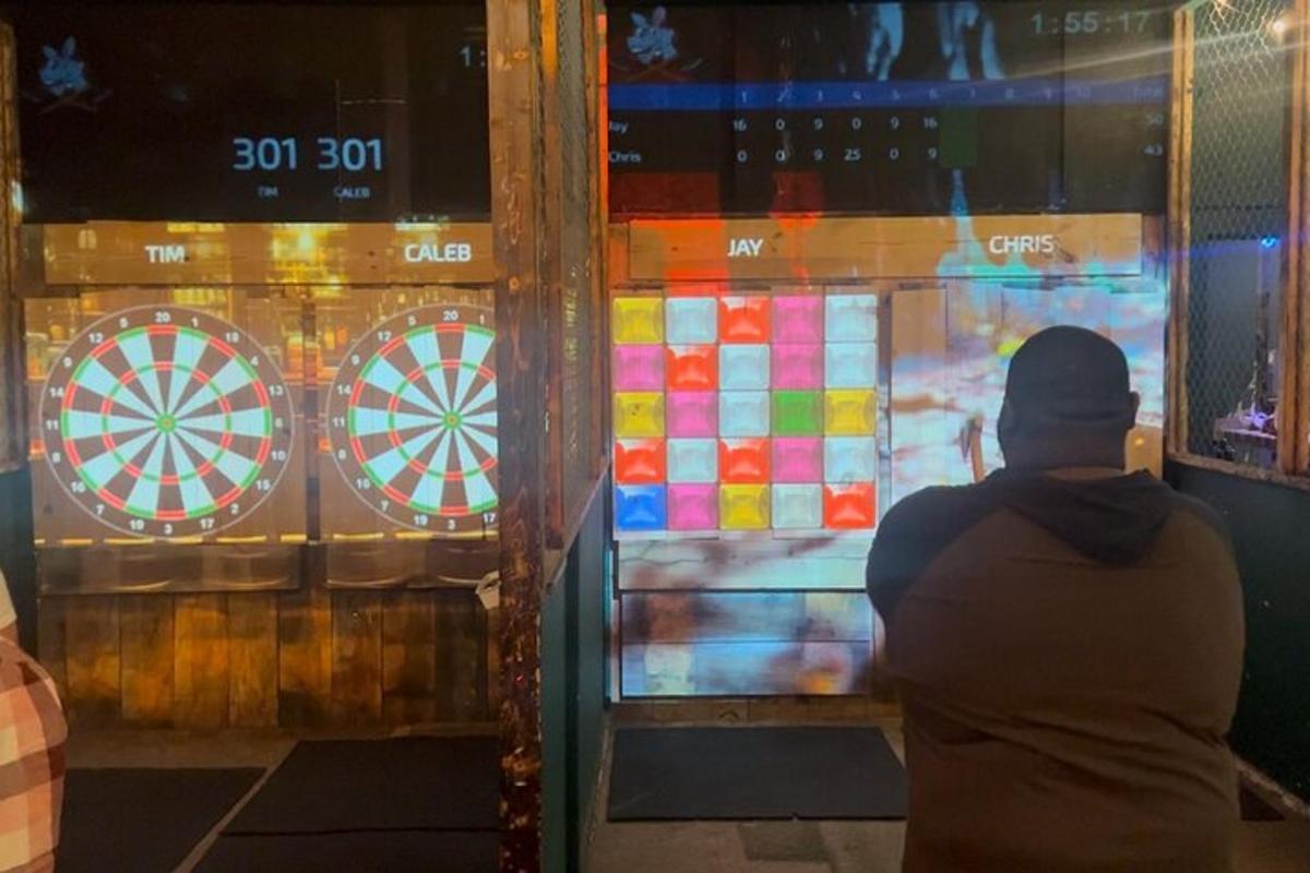 a person standing in front of a window with a dartboard