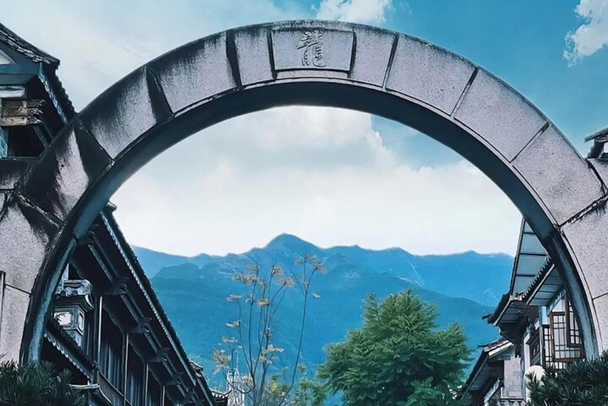 an archway over a building with a view of mountains