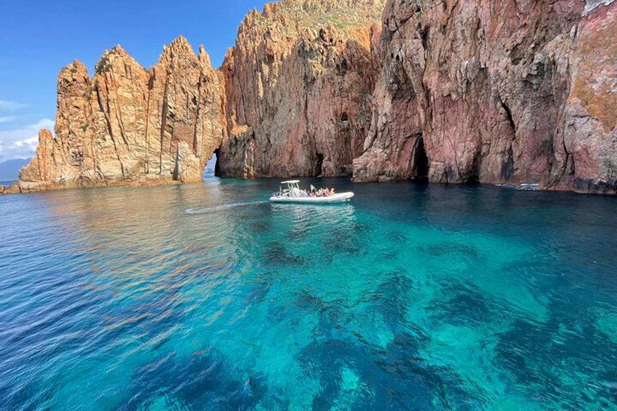 a boat in the water near a rock formation