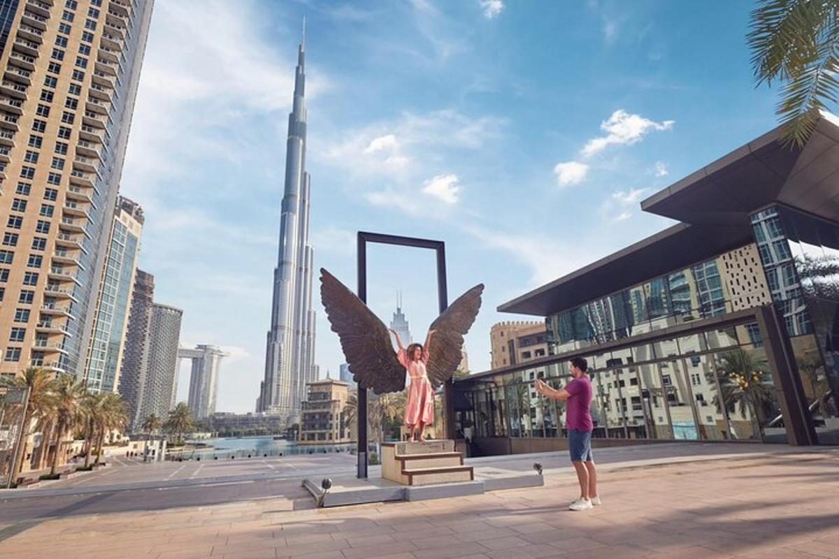 a man taking a picture of a statue of an angel