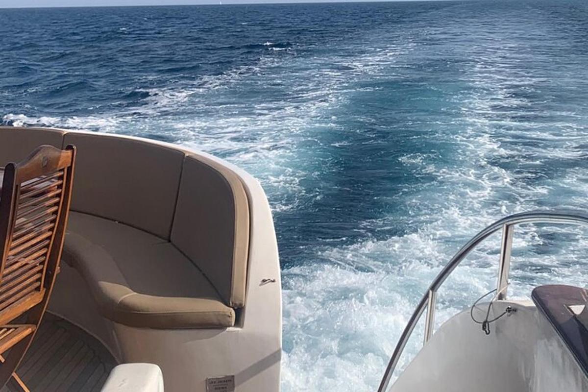 a boat with a chair on the front of the water