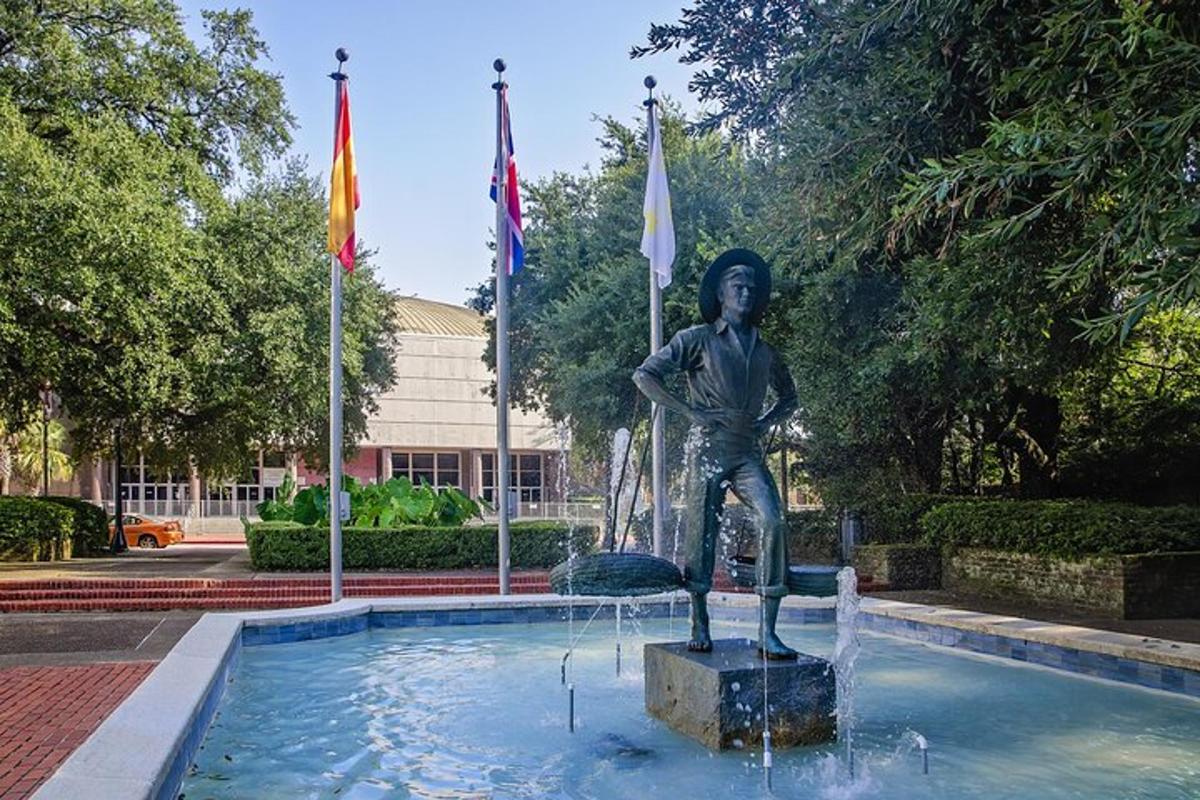 a statue of a woman standing in a pool of water
